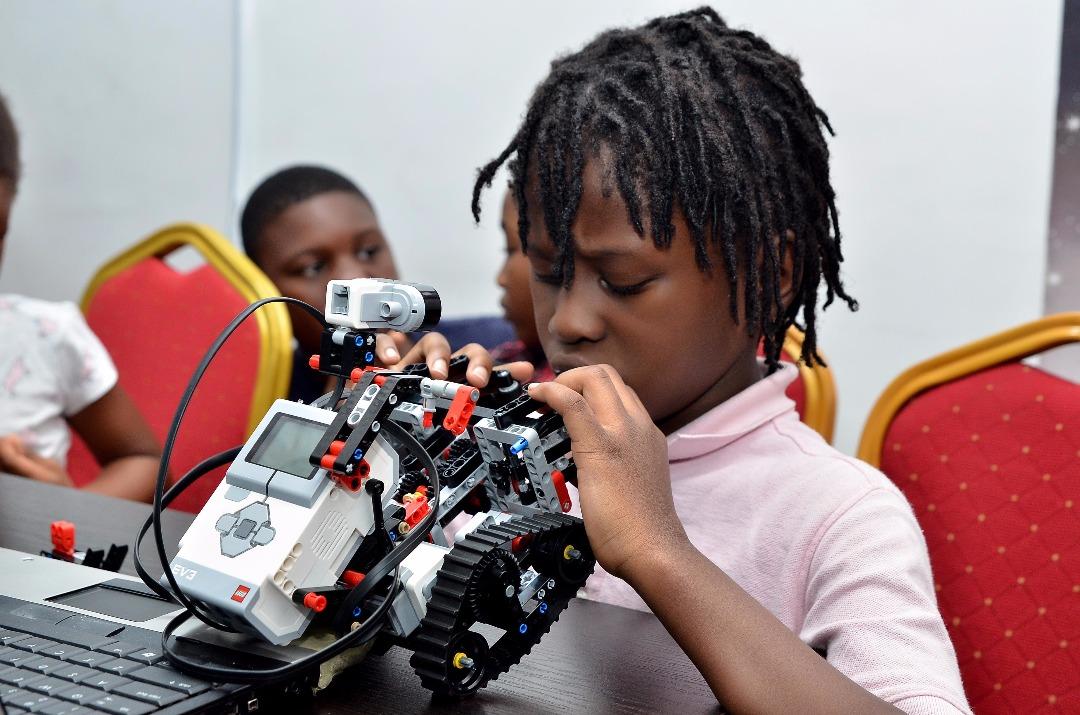 A young learner assembling a robotics kit at a Toko Academy class
