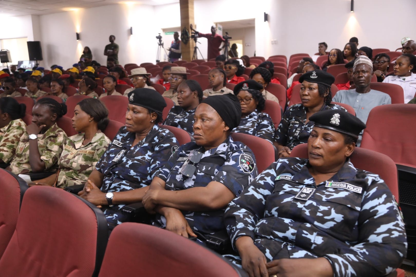 Police, army and paramilitary officers seated in an auditorium during a Toko Academy training session