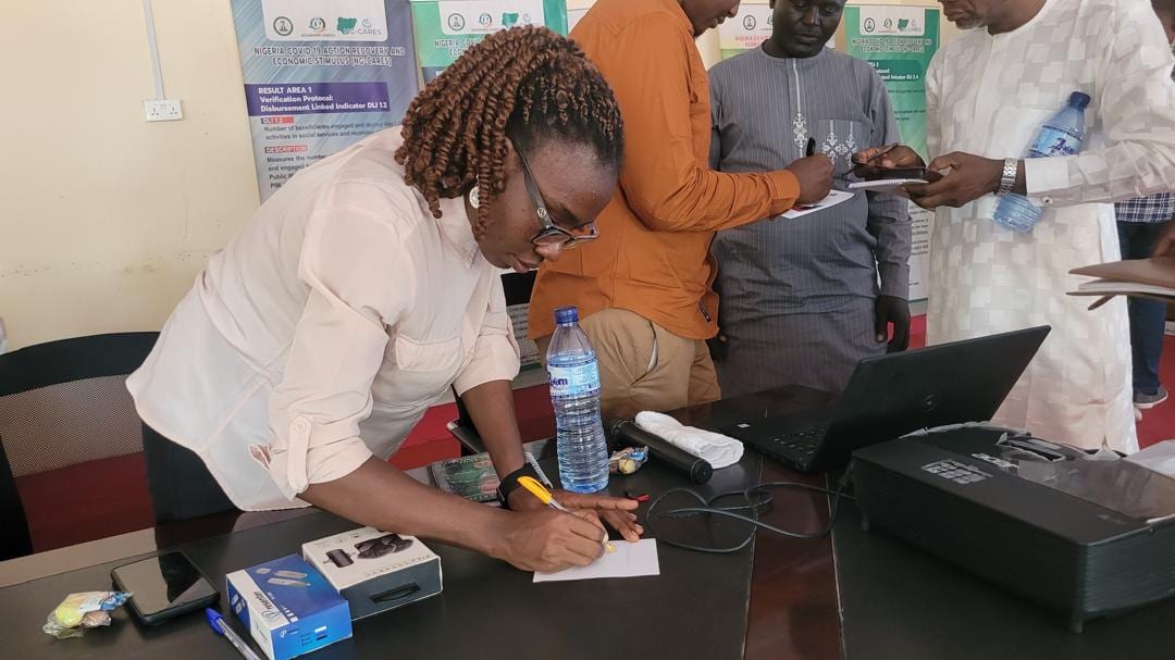 Toko Academy staff and participants going through session records together on a laptop